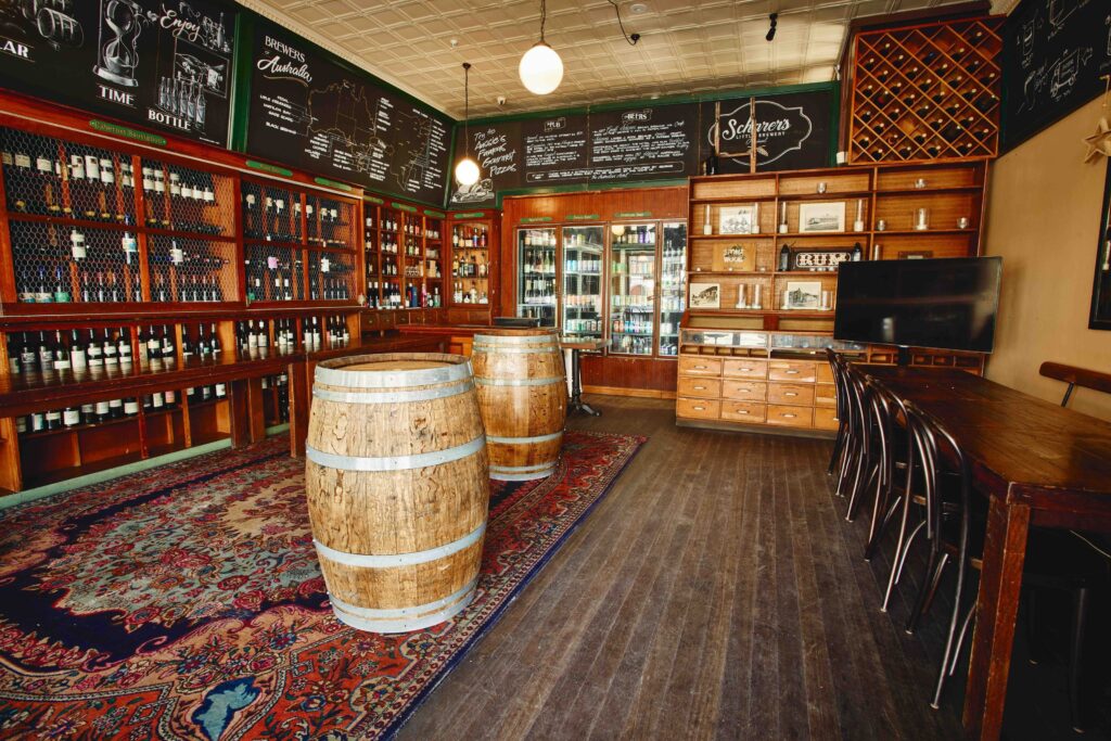 The Wine Emporium at The Australian Heritage Hotel featuring timber shelving, wine displays, barrels, and tasting space
