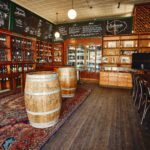 The Wine Emporium at The Australian Heritage Hotel featuring timber shelving, wine displays, barrels, and tasting space
