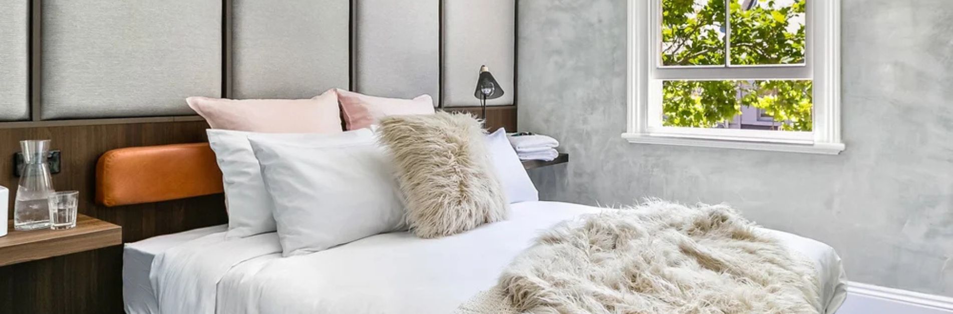 Modern bedroom at Terminus Hotel Pyrmont with plush bedding and natural light