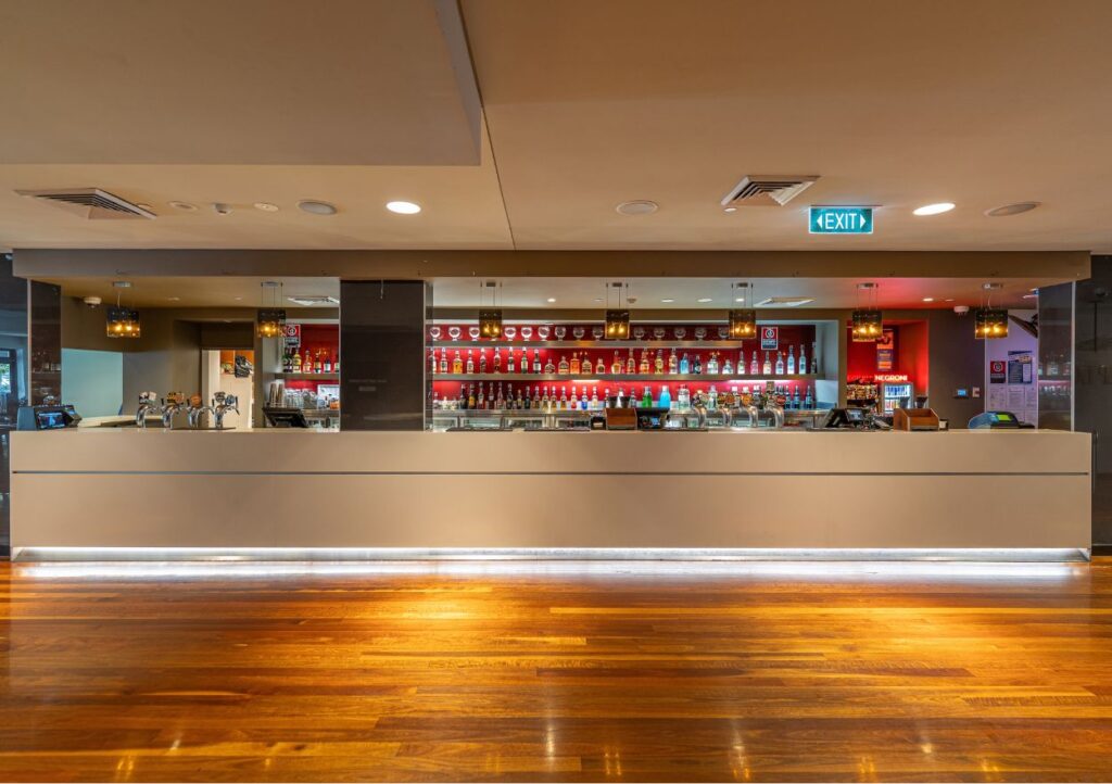 Main bar at Camden Hotel NSW featuring beer taps, premium spirits, and a contemporary hospitality space.