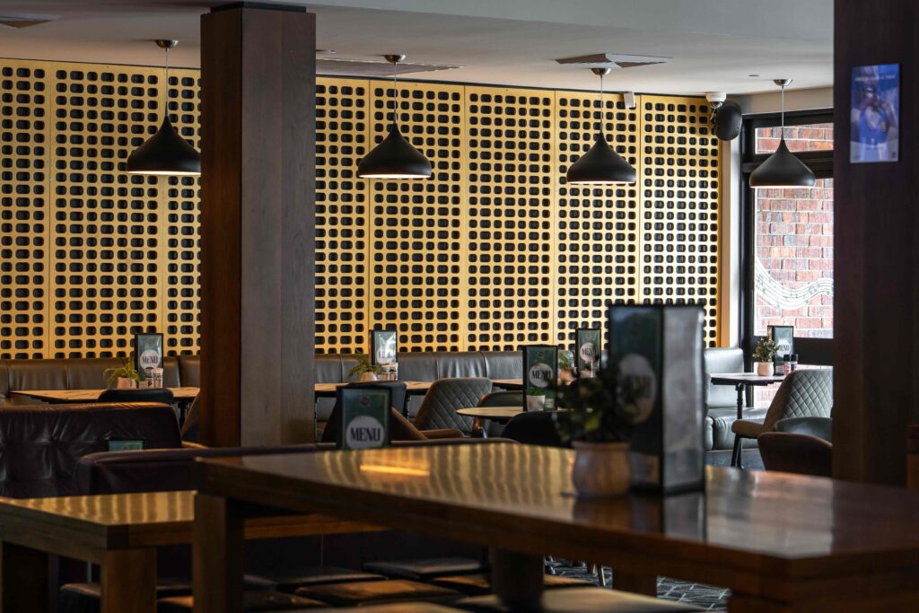 Contemporary bistro restaurant at Camden Hotel NSW featuring booth seating, timber finishes, ambient lighting, and a relaxed dining atmosphere.