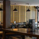 Contemporary bistro restaurant at Camden Hotel NSW featuring booth seating, timber finishes, ambient lighting, and a relaxed dining atmosphere.